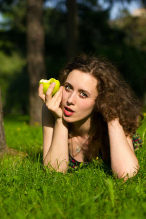 Young pretty woman eating appleの写真素材