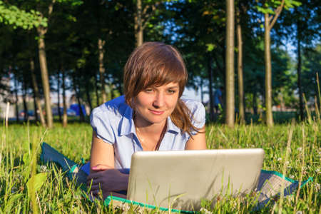 young woman with laptop outdoorsの写真素材