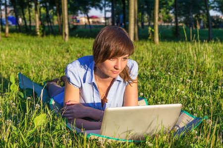 young woman with laptop outdoorsの写真素材