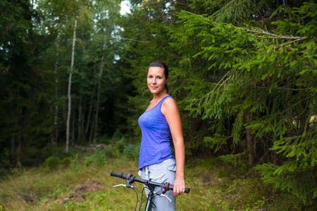 Young pretty woman and bicycleの写真素材