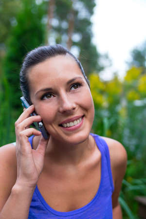 Young pretty woman and mobile phoneの写真素材