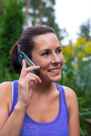 Young pretty woman and mobile phoneの写真素材