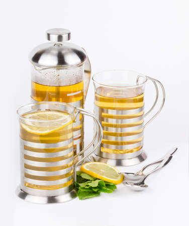 Teaapot and cups from glass with mint and lemonの写真素材