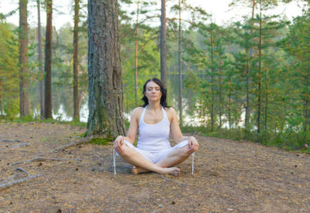 Woman meditate in the forestの写真素材
