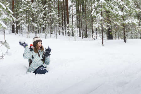 Woman throwing snowball outdoors winterの写真素材