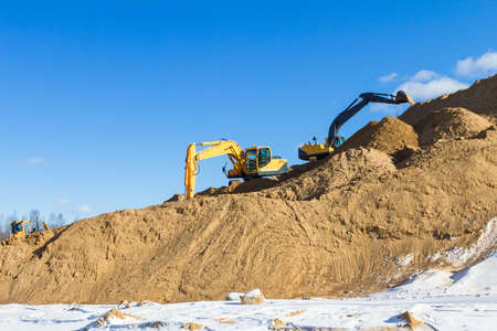 Yellow excavator at work の写真素材