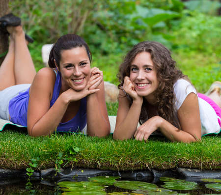 Two beautiful young brunet woman outdoorsの写真素材