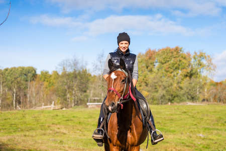 Elegant attractive woman riding a horseの写真素材