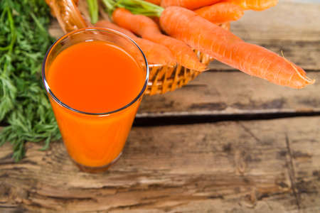 Carrot juice on wooden backgroundの写真素材