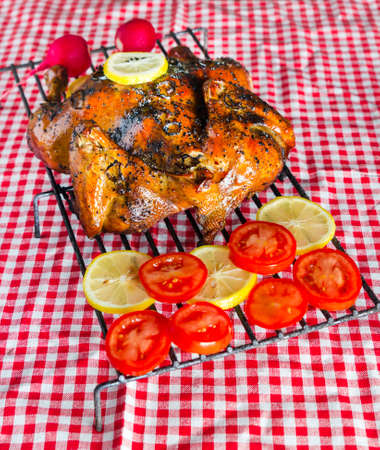 Smoked chicken on red table clothの写真素材