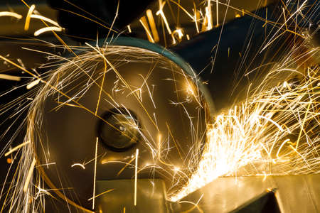 sharpening and cutting of iron by abrasive disk machineの写真素材