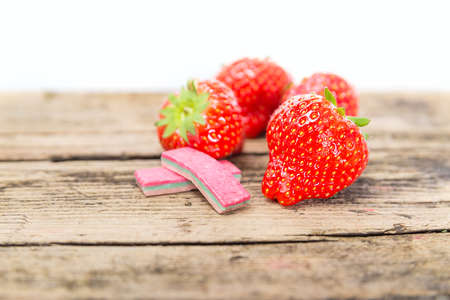 Strawberry chewing gum on a wooden backgroundの写真素材