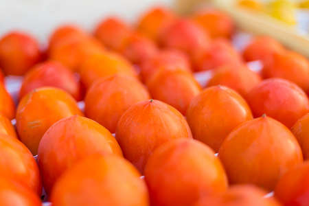 Many Persimmon fresh fruits at the marketの写真素材