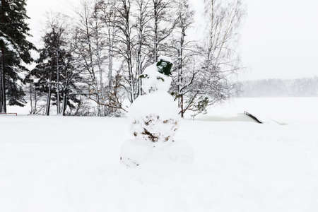 Snowman with bucket on the head in winterの写真素材