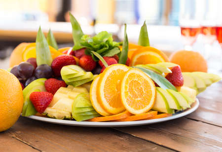 Fruit plate orange apple grapes strawberries mintの写真素材