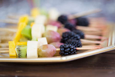 Fresh fruits on a toothpick close upの写真素材