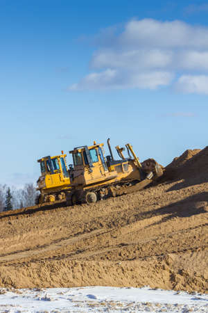 Yellow Excavator and bulldozer at Work in forest