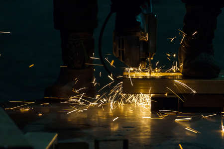 sharpening and cutting of iron by abrasive disk machineの写真素材