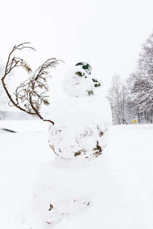 Snowman with bucket on the head in winterの写真素材