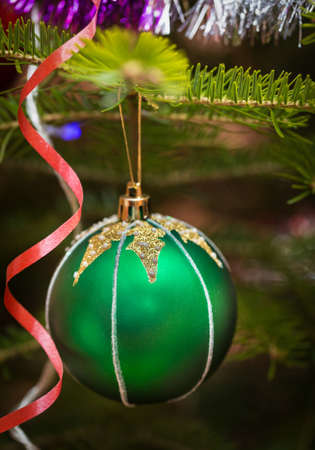 Christmas balls outdoors on a tree in snowの写真素材