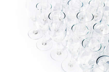 Row of champagne glasses on white backgroundの写真素材