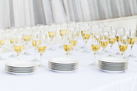 champagne glasses in a row and plates for party