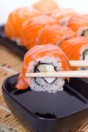 Salmon sushi rolls on a wooden backgroundの写真素材