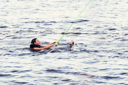 Young woman study riding wakeboarding on a lakeの写真素材