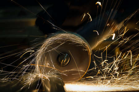 sharpening and cutting of iron by abrasive disk machineの写真素材