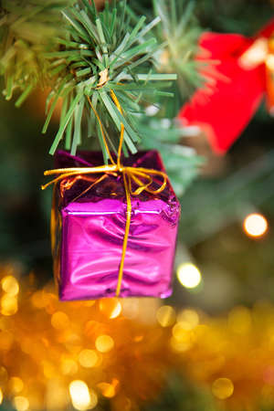 Christmas pink present box baubles on a tree
