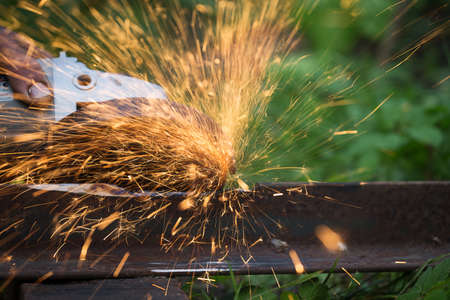 sharpening and cutting of iron by abrasive disk machineの写真素材