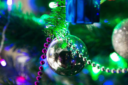 Silver Christmas composition on a treeの写真素材