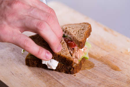 Cooking fresh homemade grilled tuna sandwich on woodの写真素材