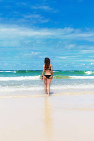 Young pretty woman have sun bath on the cost of oceanの写真素材