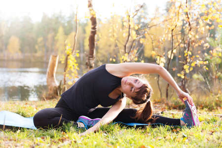 Pretty woman in yoga Parivrtta Janu Sirsasana - Head to Knee Poseの写真素材