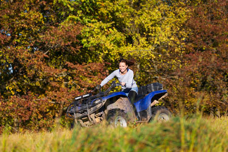 Elegant woman riding extreme quadrocycle ATVの写真素材