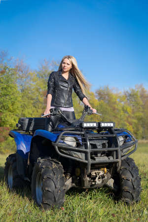 Elegant woman riding extreme quadrocycle ATVの写真素材