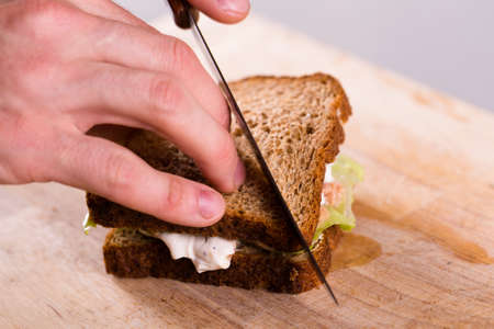 Cooking fresh homemade grilled tuna sandwich on woodの写真素材