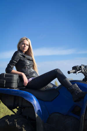 Elegant woman riding extreme quadrocycle ATVの写真素材