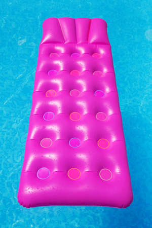 Pink air mattress in swimming pool. Holiday background. outdoorsの写真素材