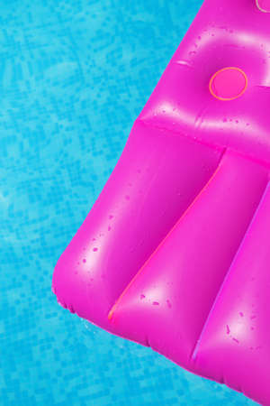 Pink air mattress in swimming pool. Holiday background. outdoorsの写真素材