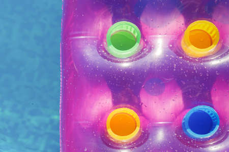 Pink air mattress in swimming pool. Holiday background. Outdoorsの写真素材