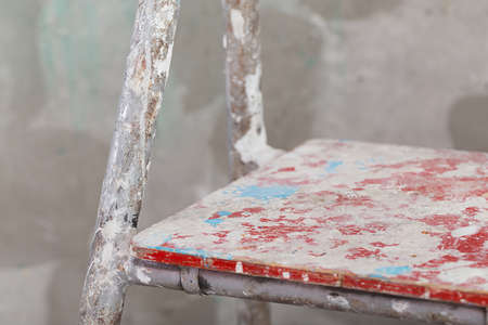 Old painted and stucco ladder on concrete wall backgroundの写真素材