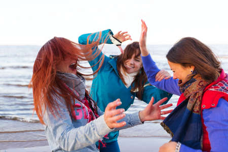 Three Fighting women near autumn lake outdoorsの写真素材