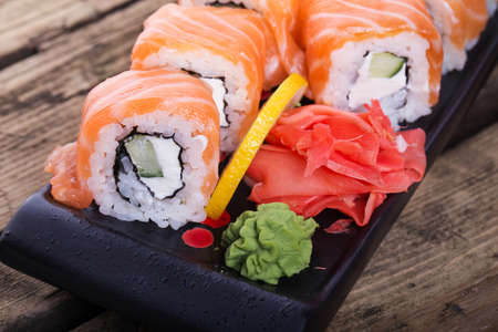 Salmon sushi rolls on a wooden backgroundの写真素材