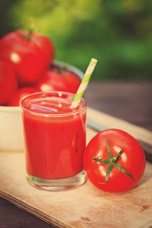 Fresh tomato juice on a wooden backgroundの写真素材