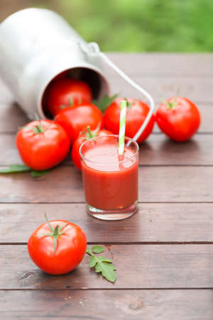 Fresh tomato juice on a wooden backgroundの写真素材
