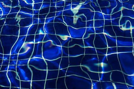 Water surface background in blue swimming pool