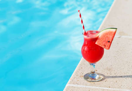 Water melon red fresh juice smoothie drink cocktail near swimming poolの写真素材