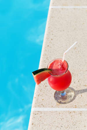 Water melon red fresh juice smoothie drink cocktail near swimming poolの写真素材